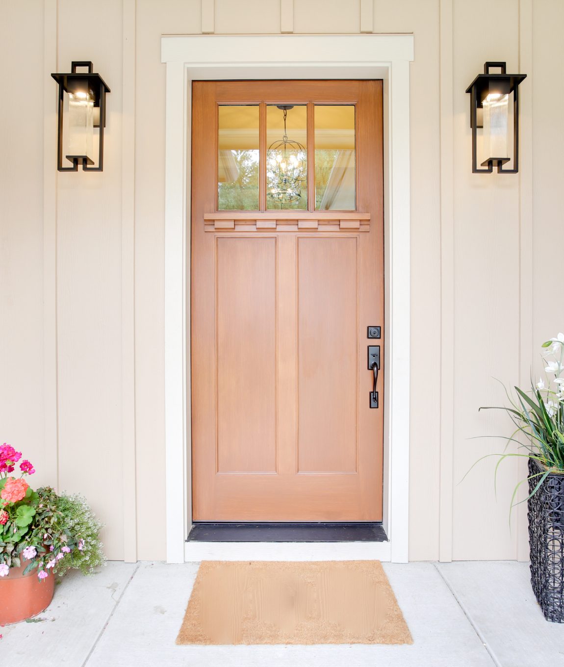 wooden door with a light on either side