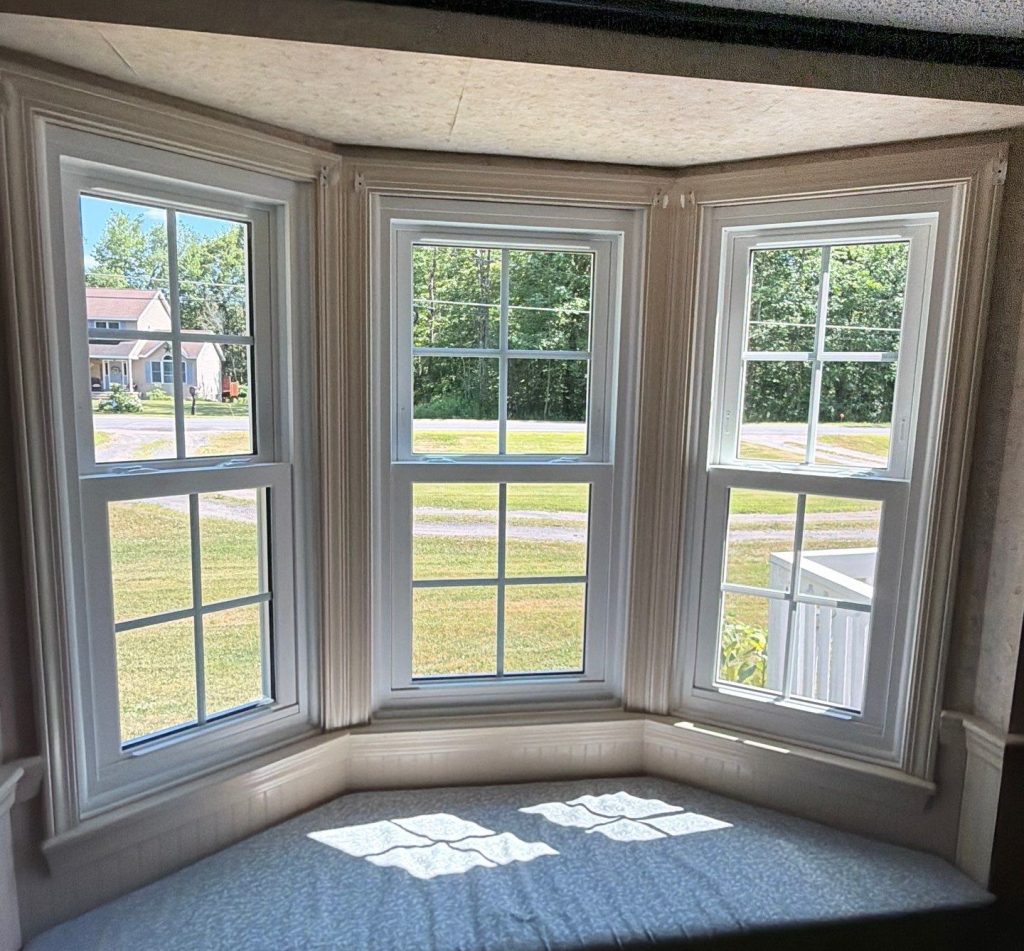 After image of a large double-hung bay window in a 1987 Rome, NY home.
