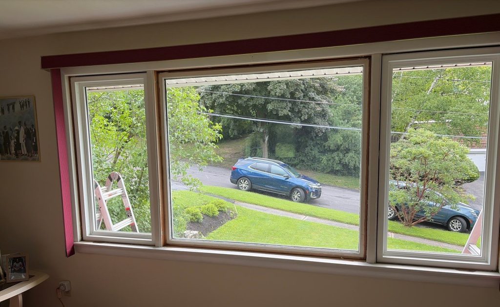 Interior after image of the newly installed picture window flanked by two deadlight windows.