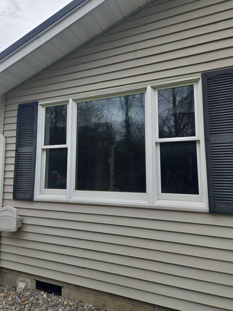 Exterior view of the replaced three-lite window before installation of the new slider windows.