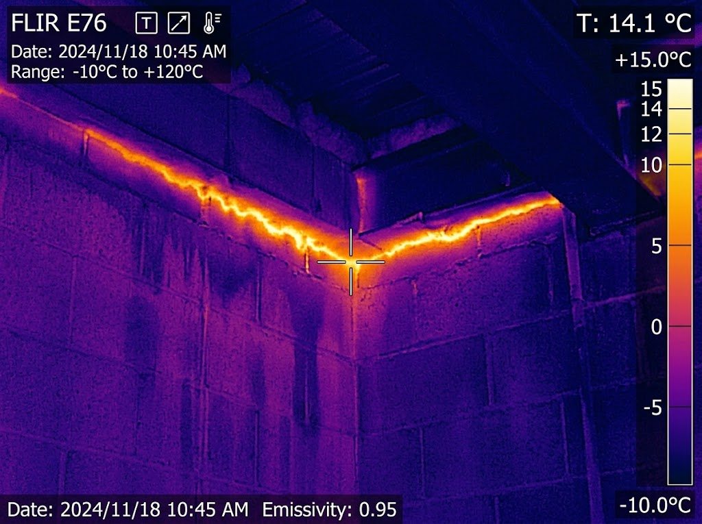 Thermal image showing heat loss at a commercial roof-to-wall joint